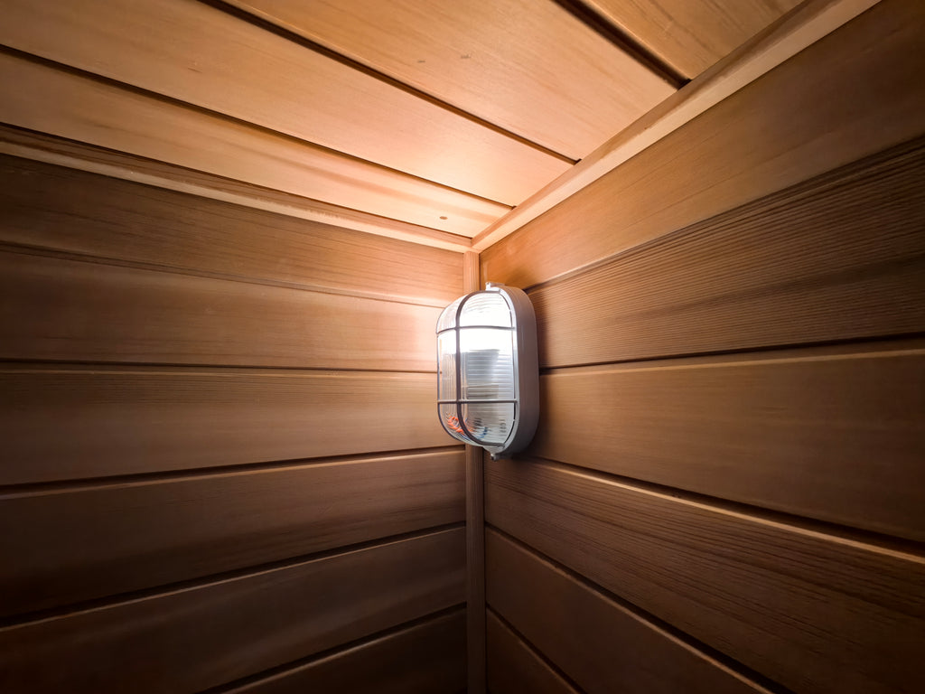 A modern - style 4 - person outdoor traditional sauna room, equipped with a wood - burning stove, a tea - making area, a sauna compartment, and comes with accessories.