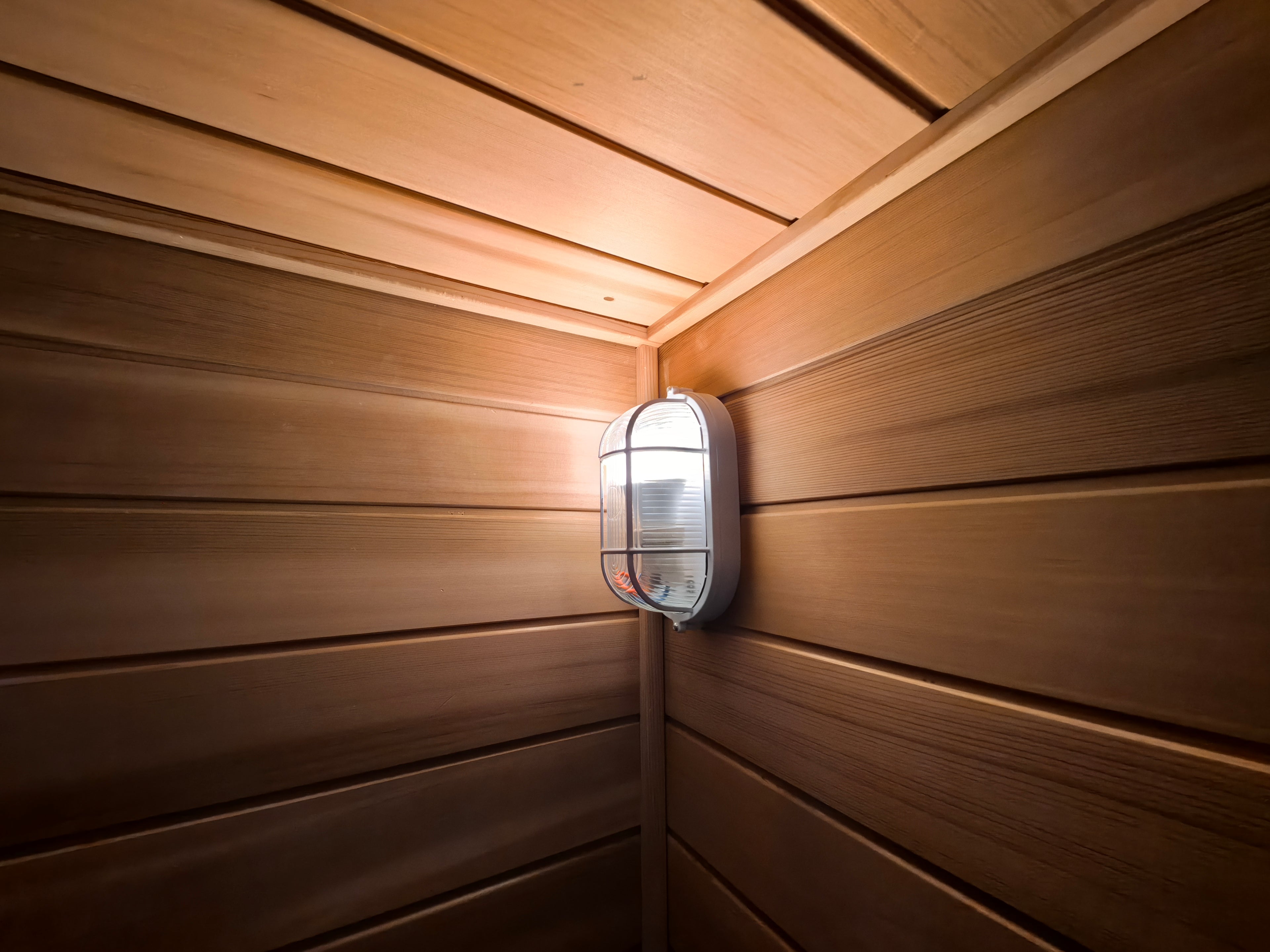 A modern - style 4 - person outdoor traditional sauna room, equipped with a wood - burning stove, a tea - making area, a sauna compartment, and comes with accessories.