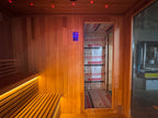 Rectangular solid - wood sauna room with an independent shower room. It uses electric - furnace for constant - temperature dry - steaming, is suitable for homes and villas, and supports non - standard customization.