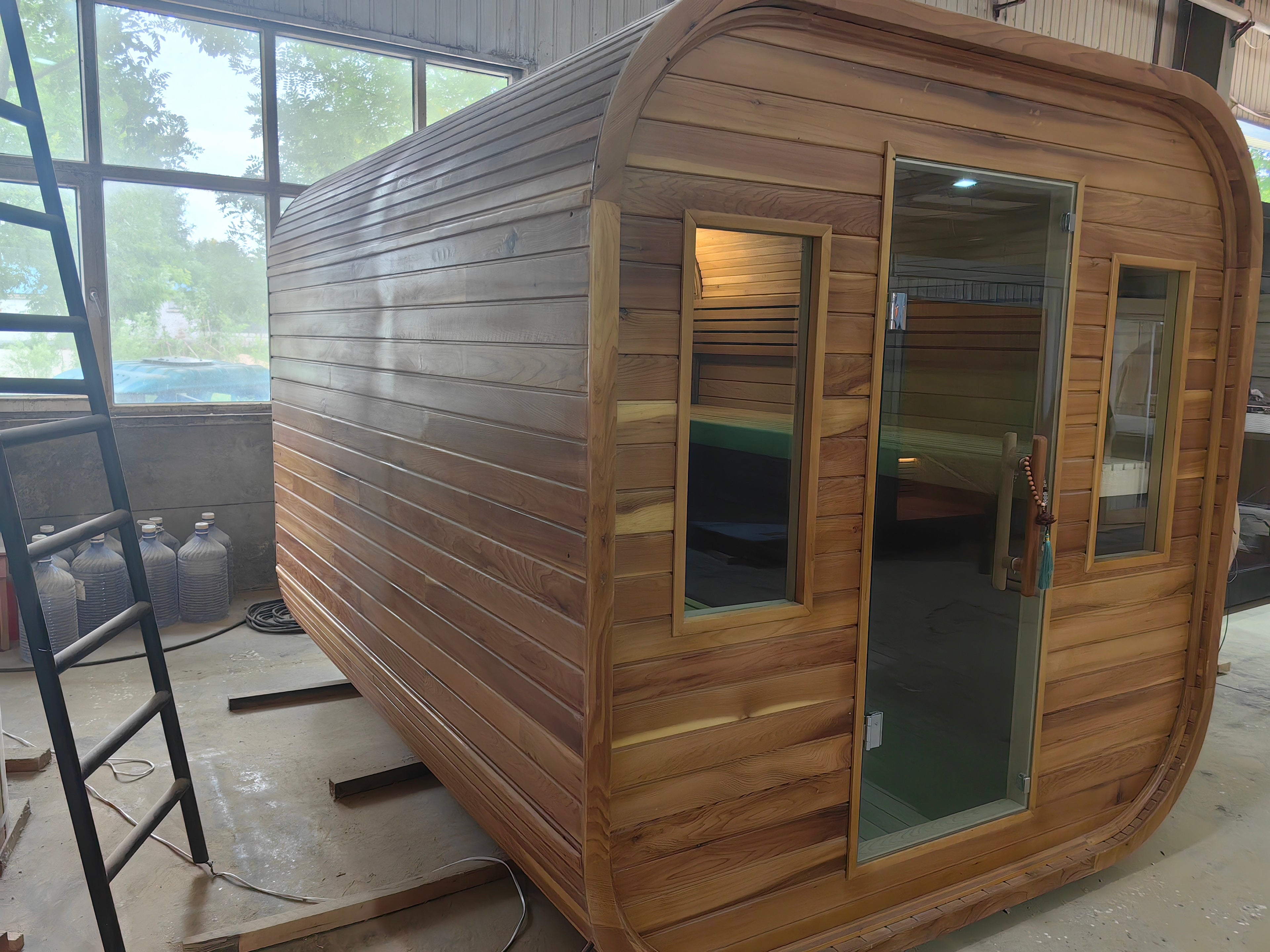 A stylish outdoor sauna cube with a wet - steam function, a computer control panel, made of western red cedar, suitable for 4 - 5 people.