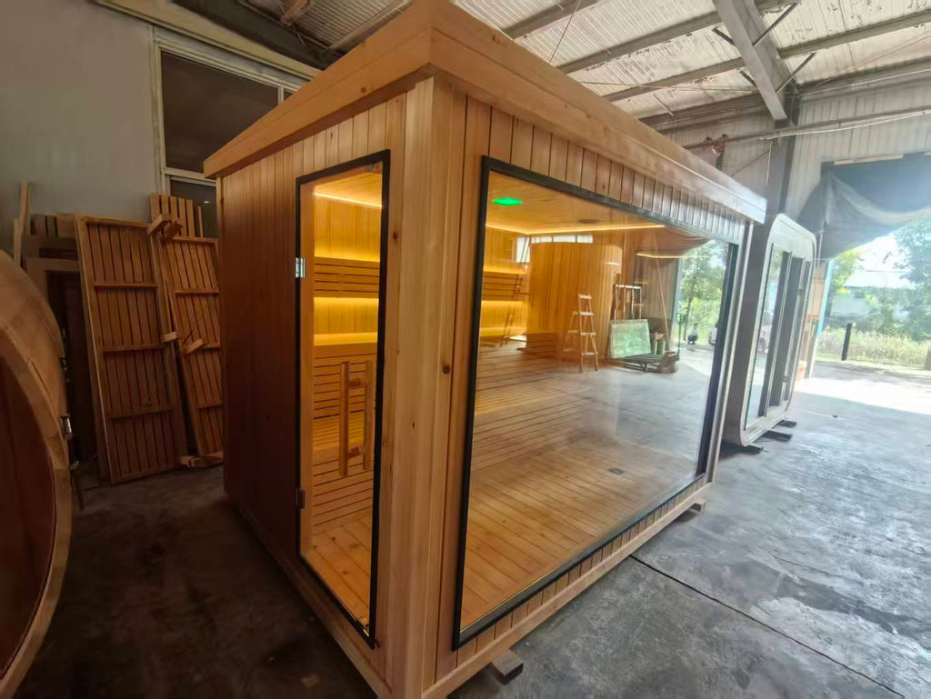 Luxurious 6 - person outdoor black square - shaped sauna. Made of spruce, in a cube shape, equipped with a 6KW heater and LED lights, suitable for use in an outdoor spa.