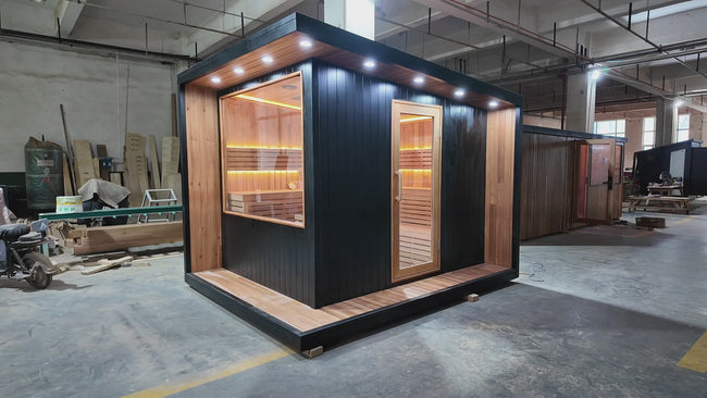 Modern - style cube - shaped sauna for 2 - 4 people. It is a solid - wood outdoor square - shaped sauna with a panoramic glass door and LED lights, suitable for use in gardens. Hover Image