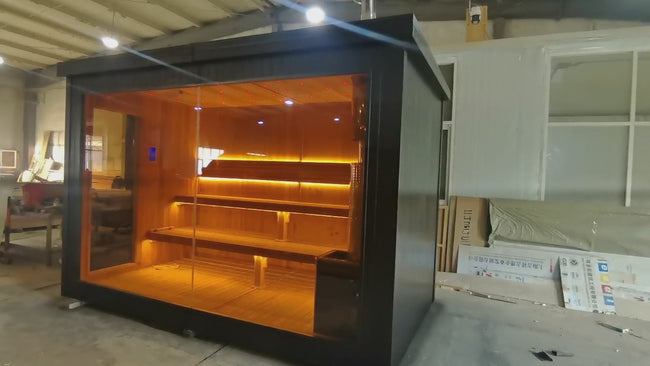 High - quality square - shaped sauna made of red cedar for 2 - 4 people. It can be operated via a control panel and is equipped with a wood - burning stove and sauna stones. Hover Image