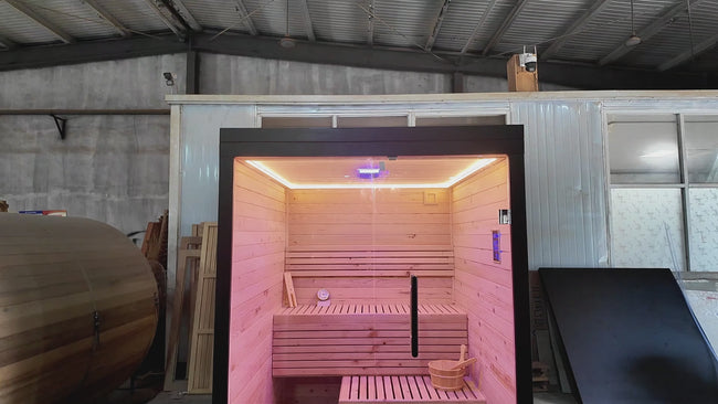 A modern indoor solid - wood sauna suite in a square - shaped room suitable for 2 - 4 people, equipped with an electric furnace and a control panel. Hover Image